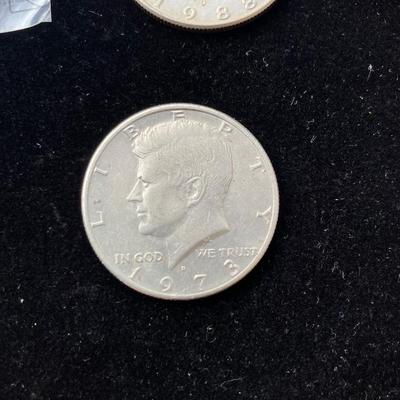 Four Kennedy Half Dollar Coins with 1964