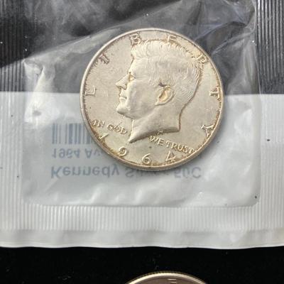 Four Kennedy Half Dollar Coins with 1964