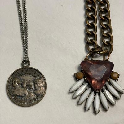 2 necklaces: 1 pink stone & Mt. Rushmore