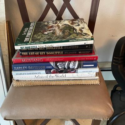 Brown counter high stool with hard cover books