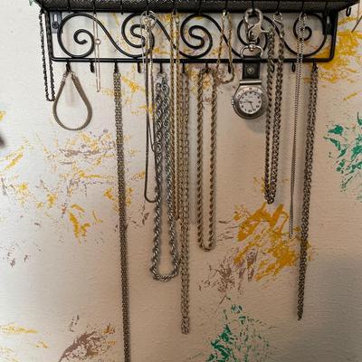 Gold and silver tone jewelry with wall hanging organizer