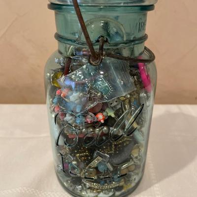 Ball canning jar filled with crafting jewelry