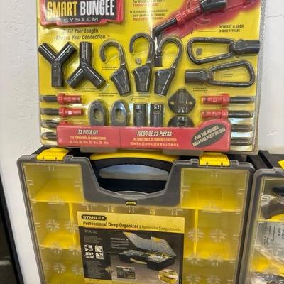 Lot 764, organizing boxes, brass lawn hardware and bungee system