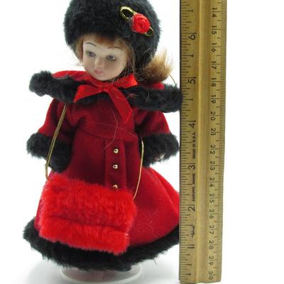 Small Porcelain Figurine in Red Winter Coat Jacket with Display Stand