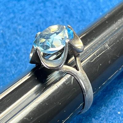 STERLING COCKTAIL RING WITH LARGE PALE BLUE PRONG SET STONE