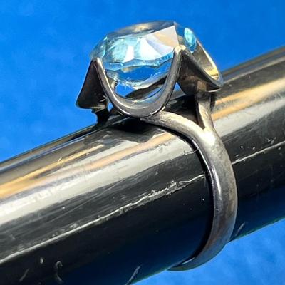 STERLING COCKTAIL RING WITH LARGE PALE BLUE PRONG SET STONE