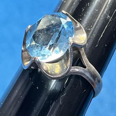 STERLING COCKTAIL RING WITH LARGE PALE BLUE PRONG SET STONE