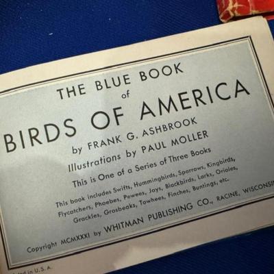 Various items vintage bird books, fish books, and a tree book with globe