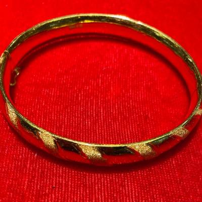 24 Karat gold ladies bangle. 2.5 Inches wide. .5 dept. 33.3 grams