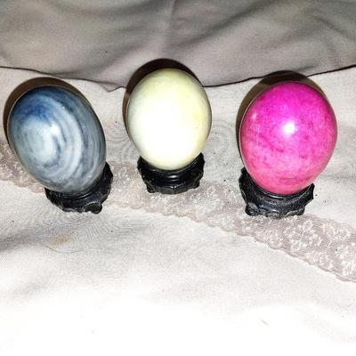 THREE COLORFUL GEO EGGS ON STANDS
