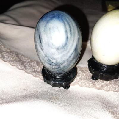 THREE COLORFUL GEO EGGS ON STANDS