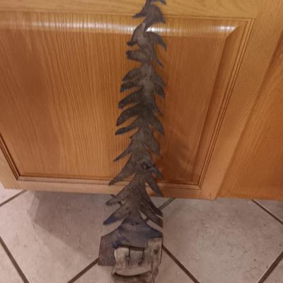 Saw blade pine tree art with candles scented candle in a jar and pillar candle.