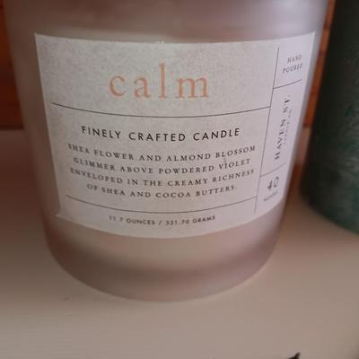 Saw blade pine tree art with candles scented candle in a jar and pillar candle.