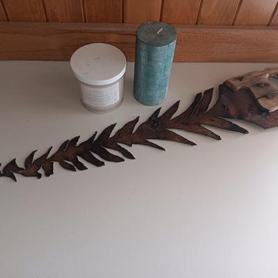 Saw blade pine tree art with candles scented candle in a jar and pillar candle.