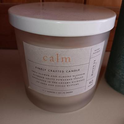 Saw blade pine tree art with candles scented candle in a jar and pillar candle.