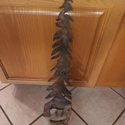 Saw blade pine tree art with candles scented candle in a jar and pillar candle.