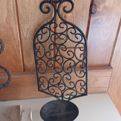 Three metal candle sconces with elegant votive candles