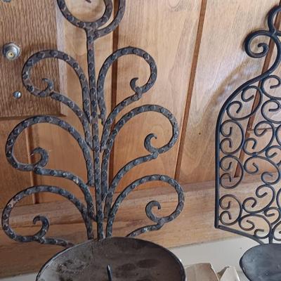 Three metal candle sconces with elegant votive candles