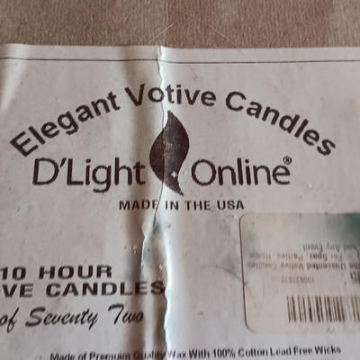 Three metal candle sconces with elegant votive candles