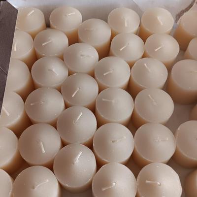 Three metal candle sconces with elegant votive candles