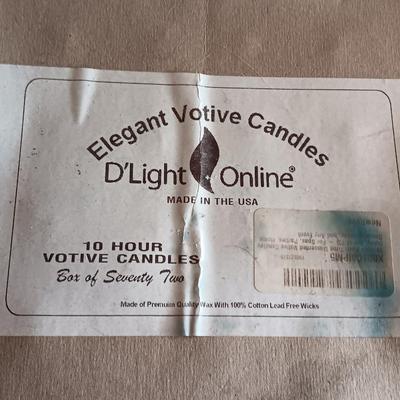 Three metal candle sconces with elegant votive candles