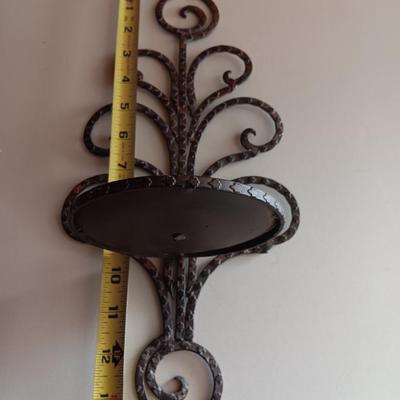 Three metal candle sconces with elegant votive candles