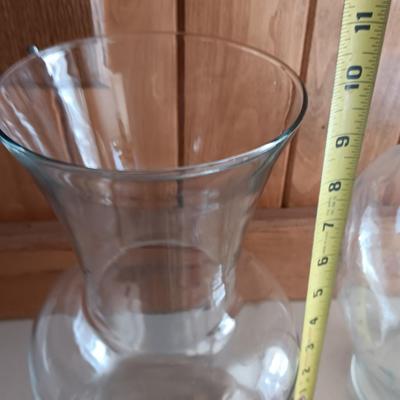 Two tall clear vases with blue toned and clear glass pebbles