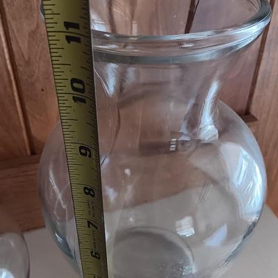 Two tall clear vases with blue toned and clear glass pebbles