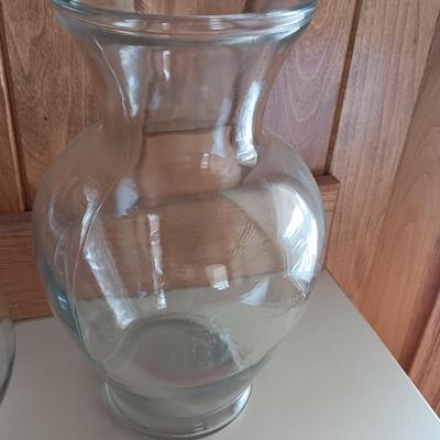 Two tall clear vases with blue toned and clear glass pebbles