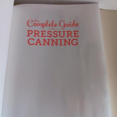 Complete Guide to Pressure canning book with canning supplies and utensils