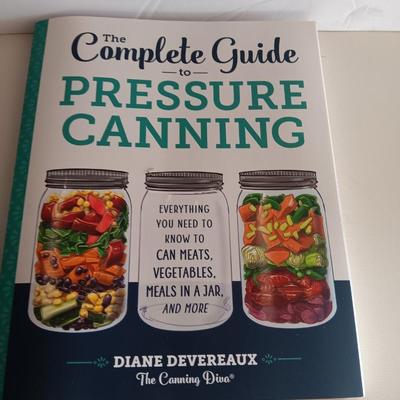 Complete Guide to Pressure canning book with canning supplies and utensils
