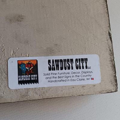 Metal Fleur De Lis accented dish with 4 large decorative balls and a sawdust city wood sign with saying.