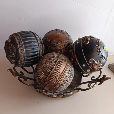 Metal Fleur De Lis accented dish with 4 large decorative balls and a sawdust city wood sign with saying.