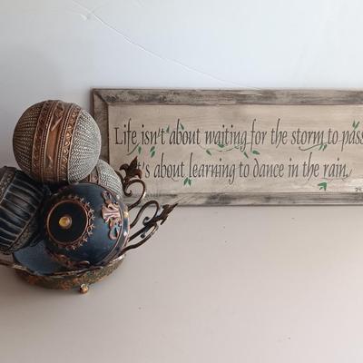 Metal Fleur De Lis accented dish with 4 large decorative balls and a sawdust city wood sign with saying.