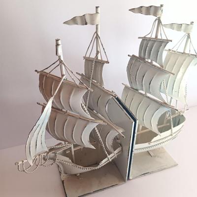 Nautical home decor - metal ship book ends with captains' wheel decor.
