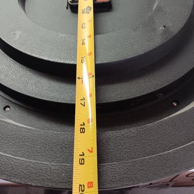 Roman numeral wall clock with woven metal vase decor