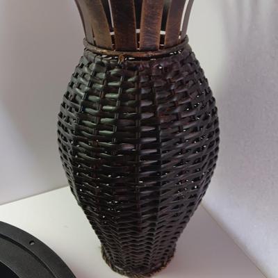 Roman numeral wall clock with woven metal vase decor