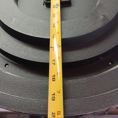 Roman numeral wall clock with woven metal vase decor