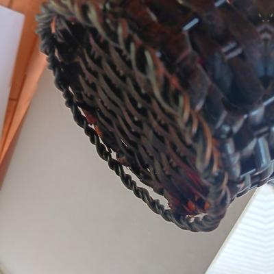 Roman numeral wall clock with woven metal vase decor