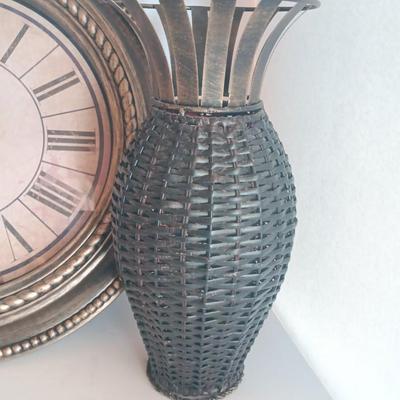 Roman numeral wall clock with woven metal vase decor