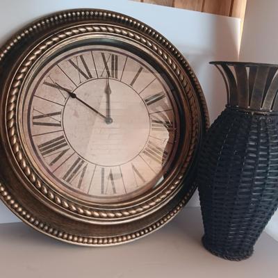Roman numeral wall clock with woven metal vase decor