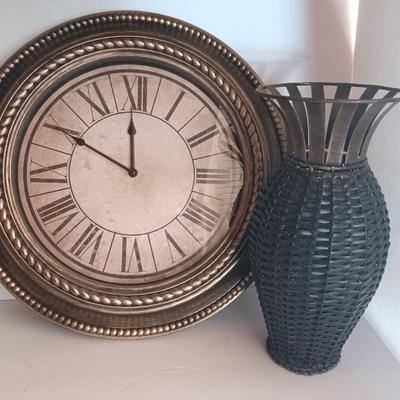 Roman numeral wall clock with woven metal vase decor