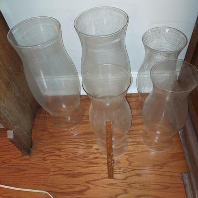 A lot of large glass hurricane shades