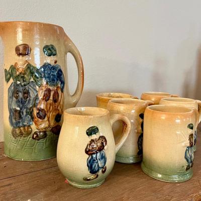 Antique Roseville pitcher and mugs