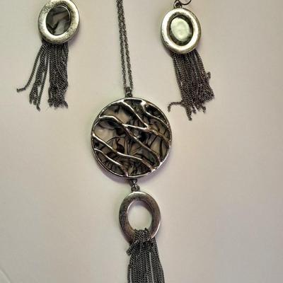 Necklace with matching earrings White and black with silver color design.