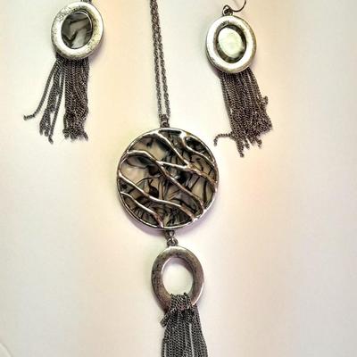 Necklace with matching earrings White and black with silver color design.