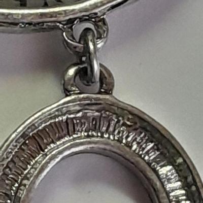 Necklace with matching earrings White and black with silver color design.