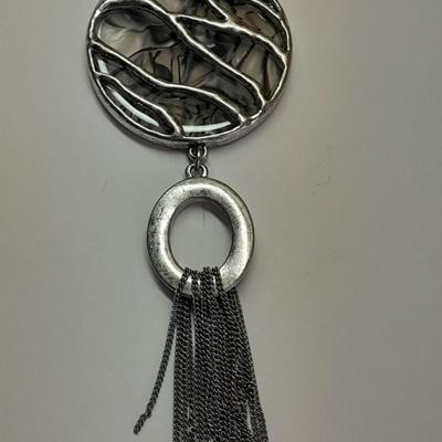 Necklace with matching earrings White and black with silver color design.