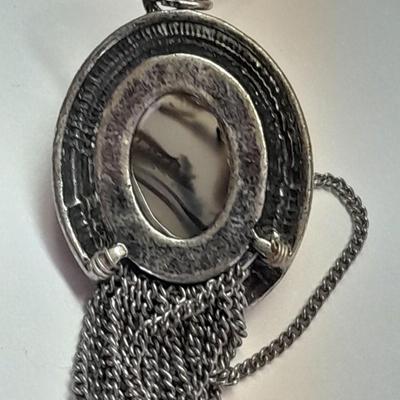 Necklace with matching earrings White and black with silver color design.