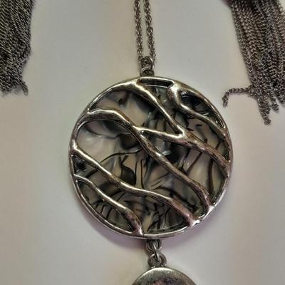 Necklace with matching earrings White and black with silver color design.